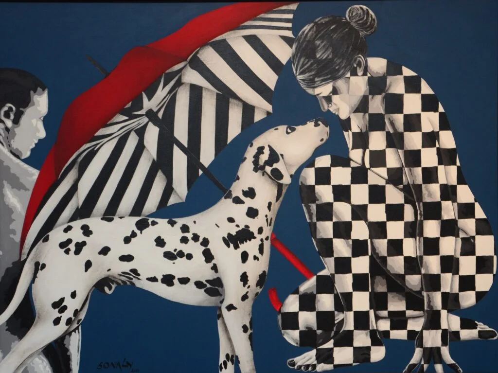 This is an original contemporary figurative painting of a rectangular shape. It is an acrylic on canvas artwork titled "Affection" with a blue-grey background. As part of its composition, it has a beautiful young lady sitting in an artistic pose on the right, beside a beach umbrella which is on the left. In front of her, on the left is her beloved pet and companion, a dalmatian dog, with the man beside him. The entire composition is in hues of black and white and a touch of red to make a perfectly balanced and attractive painting. The female figure is covered in checks which form my signature style of symetric shapes. Through this painting, I capture a moment of deep love and affection between the lady and her dog which is depicted by the loving eye contact between the two. This artwork is from my figurative series called "Shades of Love" through which I aim to portray the enduring bond between humans and their cherished animal companions. Affection, black and white art, artwork sites, cheap artwork, buy original art Enjoy free shipping on all orders, and bring a piece of lovely collectible art home today.